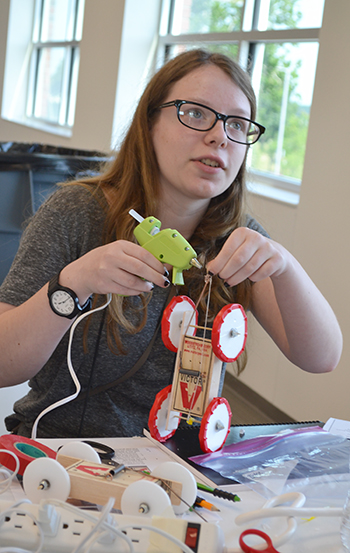 A GBAM camper works on her mousetrap car during the visit to <br />Caterpillar at the Research Park.